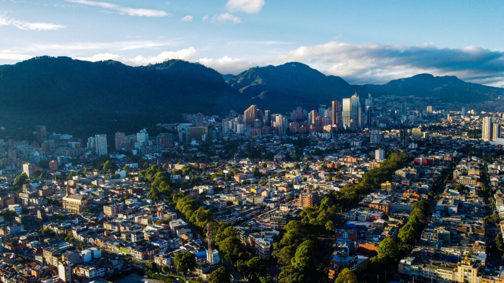 Stunning aerial photograph of Bogotá's skyline framed by lush mountains at daytime.