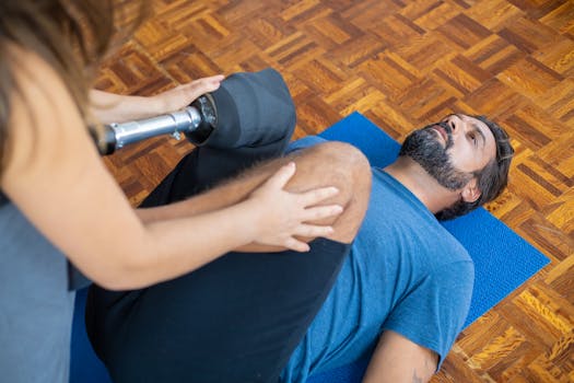 Man with prosthetic leg receiving therapy indoors, aiding recovery and rehabilitation.